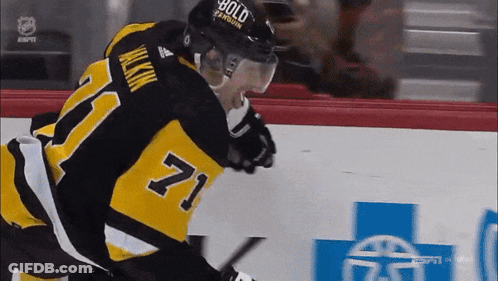 A Hockey Player Wearing A Number 71 Jersey GIF