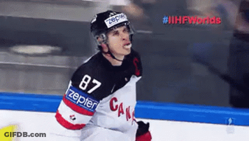 A Hockey Player Wearing A Number 87 Jersey Is Standing On A Rink . GIF