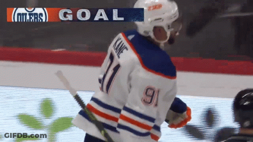 A Hockey Player Wearing A Number 9 Jersey Stands On The Ice GIF
