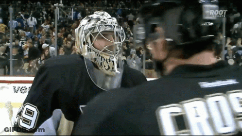 A Hockey Player Wearing A Number 9 Jersey Talks To Another Player GIF