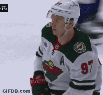 A Hockey Player Wearing A Number 97 Jersey GIF