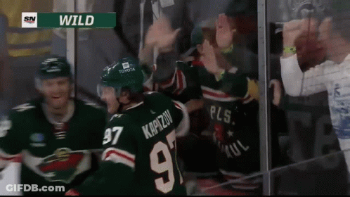 A Hockey Player Wearing A Number 97 Jersey Is Surrounded By Fans GIF
