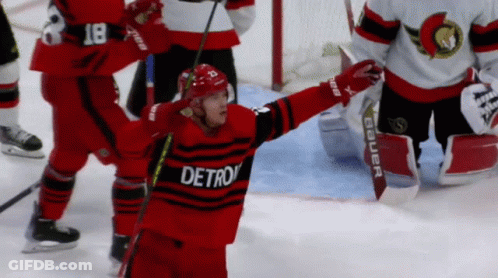 A Hockey Player Wearing A Red And Black Detroit Jersey GIF