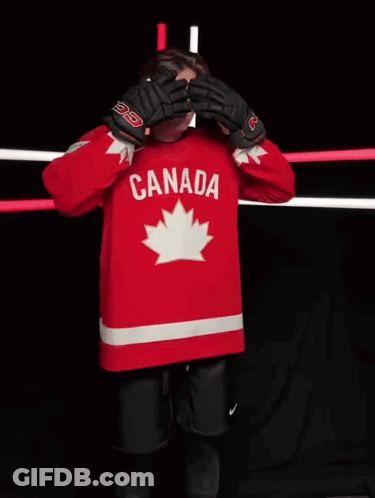 A Hockey Player Wearing A Red Canada Jersey Stands In Front Of A Camera GIF