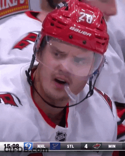 A Hockey Player Wearing A Red Helmet With The Number 20 GIF