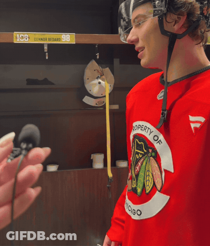 A Hockey Player Wearing A Red Jersey That Says " Property Of Chicago " GIF