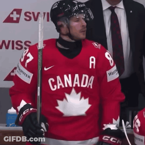 A Hockey Player Wearing A Red Jersey With Canada On It GIF