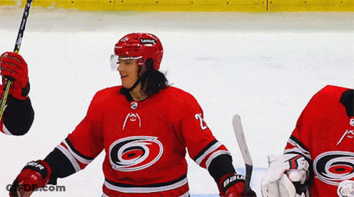 A Hockey Player Wearing A Red Jersey With The Number 2 On It GIF