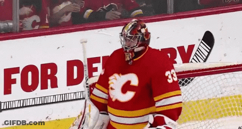 A Hockey Player Wearing A Red Jersey With The Number 33 GIF