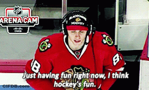 A Hockey Player Wearing A Red Jersey With The Number 8 GIF