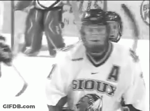 A Hockey Player Wearing A Sioux Jersey Is On The Ice GIF