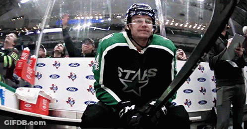 A Hockey Player Wearing A Stars Jersey Holds His Stick GIF