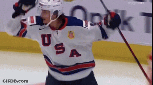 A Hockey Player Wearing A Usa Jersey Is Holding A Stick GIF