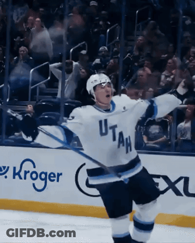 A Hockey Player Wearing A Utah Jersey Celebrates His Goal GIF