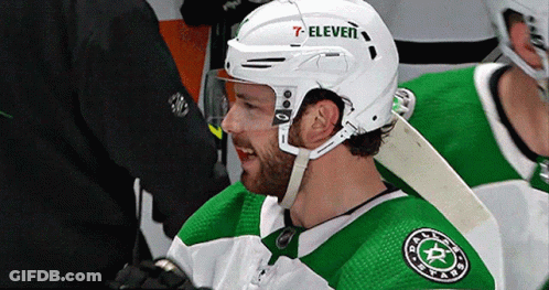 A Hockey Player Wearing A White Helmet With 7 Eleven On It GIF