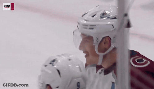 A Hockey Player Wearing A White Helmet With The Letter O On His Jersey GIF