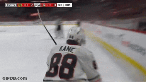 A Hockey Player Wearing A White Jersey With Kane On The Back GIF