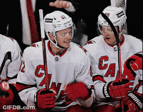 A Hockey Player Wearing A White Jersey With The Letter G On It GIF