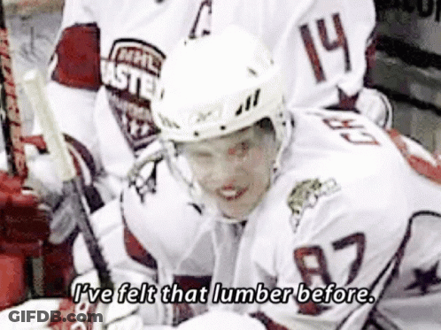 A Hockey Player Wearing A White Jersey With The Number 14 On It GIF