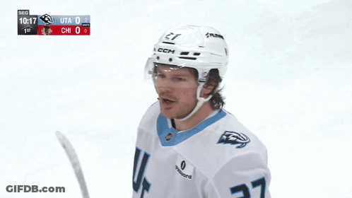 A Hockey Player Wearing A White Jersey With The Number 27 GIF