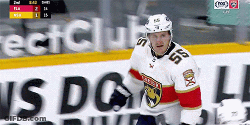 A Hockey Player Wearing A White Jersey With The Number 55 On It GIF