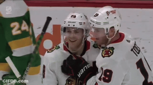 A Hockey Player Wearing A White Jersey With The Number 9 On It GIF
