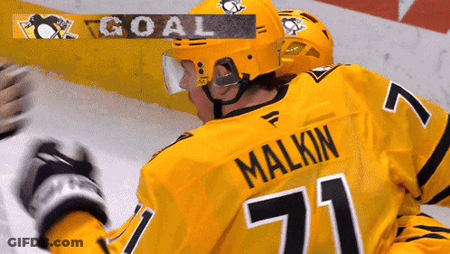 A Hockey Player Wearing A Yellow Jersey With The Name Malkin On It GIF