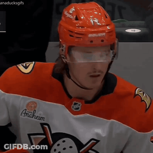A Hockey Player Wearing An Anaheim Jersey And A Red Helmet GIF