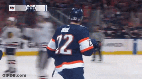 A Hockey Player Wearing The Number 12 Jersey GIF