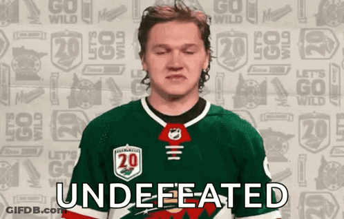 A Hockey Player With His Eyes Closed And The Word " Undefeated " On His Chest GIF