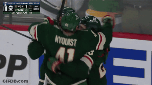 A Hockey Player With Nyquist On His Jersey Hugging His Teammates GIF