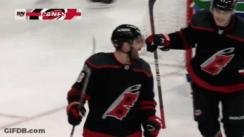 A Hockey Player With The Letter B On His Jersey Is Holding A Hockey Stick GIF