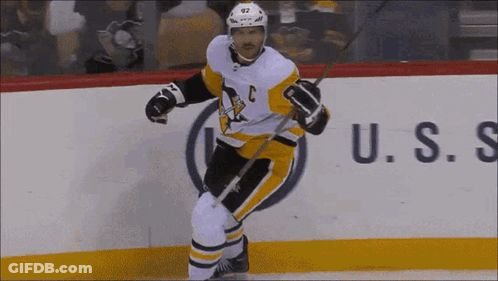 A Hockey Player With The Letter C On His Jersey Is Holding A Stick GIF