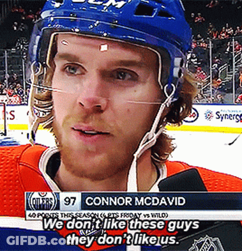 A Hockey Player With The Name Connor Mcdavid On The Bottom Of The Screen GIF