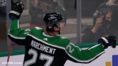 A Hockey Player With The Name Marchment On The Back Of His Shirt GIF
