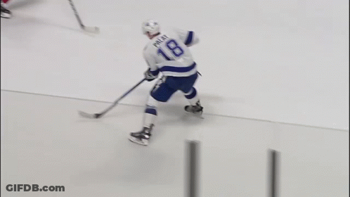 A Hockey Player With The Name Rice On His Jersey Is Holding A Hockey Stick GIF