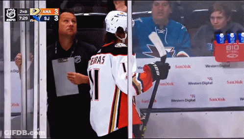 A Hockey Player With The Number 1 On His Jersey Stands In Front Of A Sandisk Sign GIF