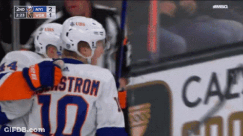 A Hockey Player With The Number 10 On His Back Is Hugging Another Player GIF
