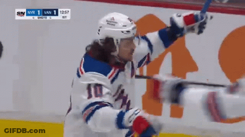 A Hockey Player With The Number 10 On His Jersey Celebrates GIF