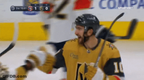 A Hockey Player With The Number 10 On His Jersey Is Celebrating GIF