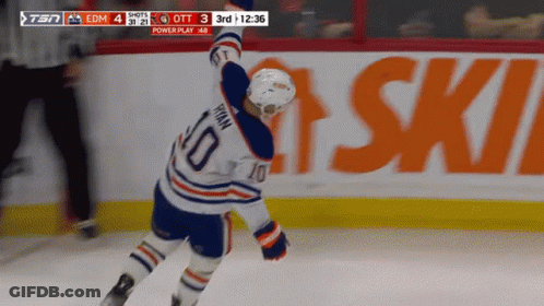A Hockey Player With The Number 10 On His Jersey Stands On The Ice GIF