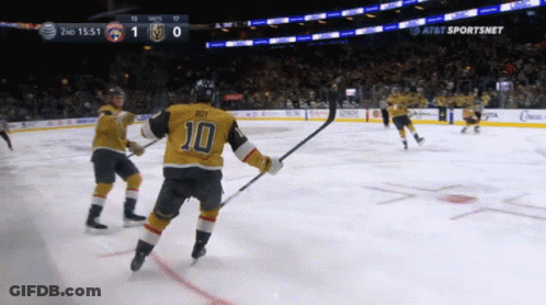 A Hockey Player With The Number 10 On His Jersey Stands On The Ice GIF