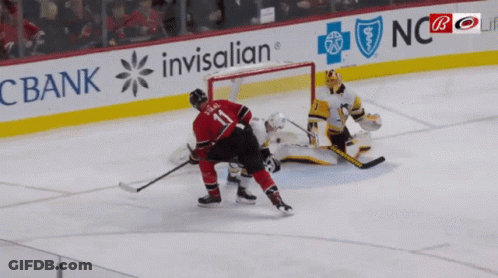 A Hockey Player With The Number 11 On His Back GIF