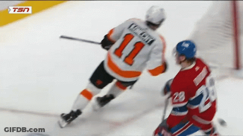 A Hockey Player With The Number 11 On His Jersey Is Being Chased By Another Player GIF