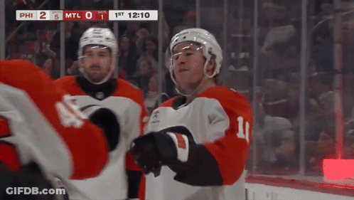 A Hockey Player With The Number 11 On His Jersey Stands On The Ice GIF