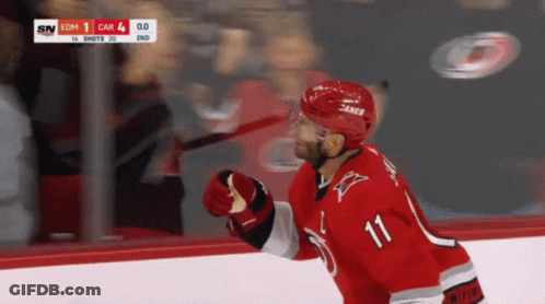 A Hockey Player With The Number 11 On His Shirt GIF