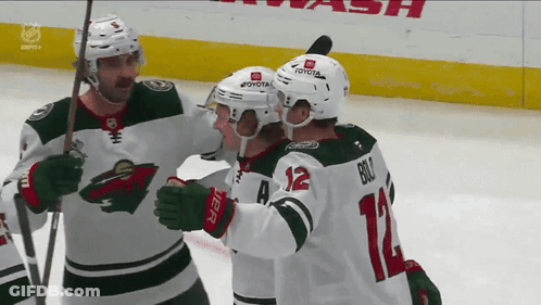 A Hockey Player With The Number 12 On His Back GIF