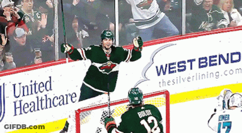 A Hockey Player With The Number 12 On His Jersey Celebrates GIF