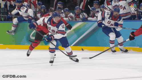 A Hockey Player With The Number 12 On His Jersey Skates On The Ice GIF
