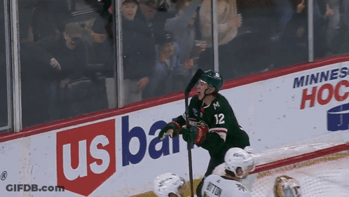 A Hockey Player With The Number 12 On His Jersey Stands On The Ice GIF